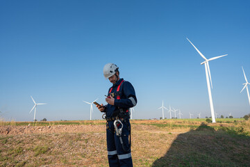Wall Mural - engineer wearing uniform inspection and survey work in wind turbine farms rotation to generate elect