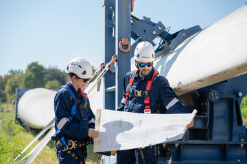 Wall Mural - engineer team working in wind turbine farm. maintenance engineer working in wind turbine.