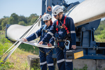 Wall Mural - engineer team working in wind turbine farm. maintenance engineer working in wind turbine.