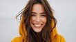 © Matt - Young woman with long wavy brown hair smiling in bright yellow top
