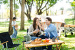 © Nuttapong punna - Asian couple enjoys a peaceful camping morning with coffee, breakfast, music, and devices in nature with love