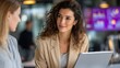 © underground - Two women in business casual attire having a conversation at a modern office setting. Possible use Business collaboration, networking, teamwork