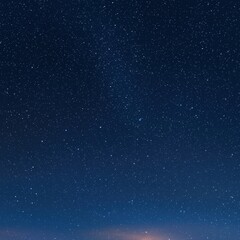 Poster - A majestic night sky with countless stars sparkling brightly over the quiet landscape below
