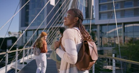 Poster - University, woman and walking with back at campus for learning, knowledge and travel to academy. Students, friends and people by buildings on bridge for higher education, scholarship and journey