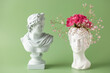 © murziknata - Creative art concept plaster head ancient sculpture with hair fresh flowers gypsophila and hydrangea on green background. Copy space