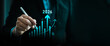 © Sutthiphong - Strategic business growth and financial planning concept for 2026 with businessman using digital pen to draw virtual chart. Investment strategy, market trend, goal setting, data analysis innovation