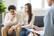 © KMPZZZ - Psychology, depression asian young couple love woman and male patient consulting problem mental health with psychologist, psychiatrist at clinic together, wife encouraging husband, therapy health care