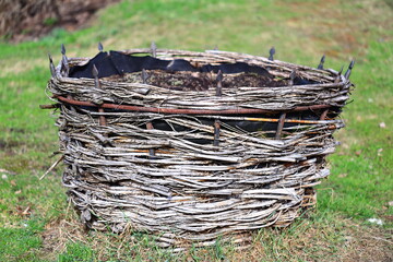 Poster - A wicker basket sits atop a lush green grassy field, waiting to be used or admired.