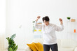 © satura_ - Energetic woman dancing at home while enjoying music. Lifestyle, movement and positive emotions concept. Copy space