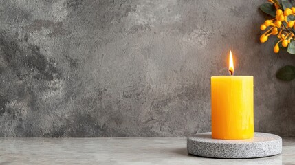 Poster - Bright Orange Candle on Stone Base with Gray Background and Yellow Flowers