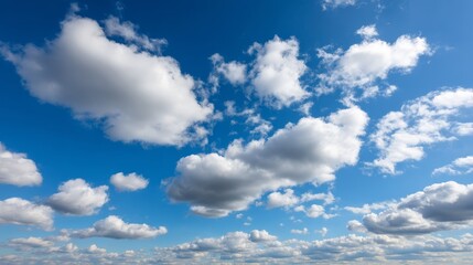 Fototapete - Fluffy cumulus clouds float gently across a bright blue sky, creating a serene atmosphere, perfect for design projects needing tranquil backdrops