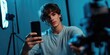 © Denis - An individual engaged in photography, surrounded by equipment and taking a selfie with a smartphone.