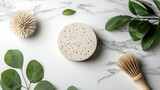 Natural pumice stone with green leaves and brushes on marble
