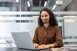 © Liubomir - Support service worker working inside office with laptop and headset. Businesswoman using laptop for video call, online business meeting conference.