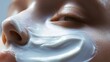 © Bayram - Close-up View of Skin Covered With a Light White Cream Highlighting Smooth Texture and Shine for Skincare Routine Enhancement
