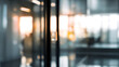 © Ganesha88 - Blurred office interior with door in focus modern workspace professional environment calm view