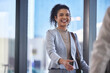 © peopleimages.com - Business people, welcome and woman with handshake, agreement and greeting in airport lobby. Person, employee and travel agent with confidence, shaking hands and gesture for thank you and b2b deal