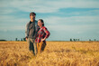 © Bits and Splits - Male and female farmer posing in ripe wheat field ready for harvest