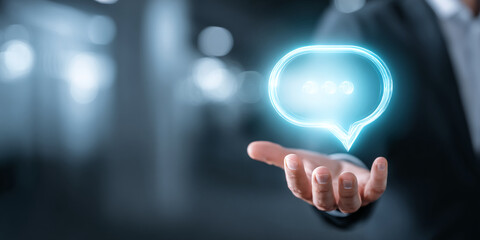 Poster - Glowing cyan speech bubble hovers above an outstretched hand, symbolizing communication, support, or online interaction