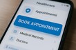© Creative mind - A close-up of a smartphone screen showing a healthcare app with a prominent “Book Appointment” button. Concept of telemedicine scheduling and patient convenience.