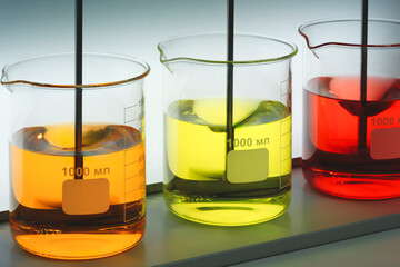 Poster - Mixers in the laboratory stir multi-colored liquids in chemical flasks. Analytics medicine pharmaceuticals microbiology concept
