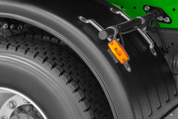 Aufkleber - A close up of a truck tire with a yellow light on the side. The tire is black and has a white rim.