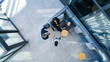 © Dean2000/peopleimages.com - Meeting, teamwork and business people in office lobby for corporate payroll planning from above. Discussion, collaboration and group of finance advisors for b2b company investment growth in workplace