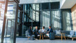 © Dean2000/peopleimages.com - Business travel, meeting and people on couch in airport, terminal lounge and lobby with professional employees. Entrepreneurs, luggage and collaboration for b2b trip, work convention and diversity