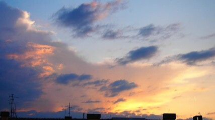 Poster - A stunning pink yellow evening cloud emerges gracefully in the twilight sky, casting a serene glow. This captivating display captures the essence of a peaceful evening. Time lapse. Dramatic sky