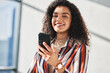 © peopleimages.com - Woman, smartphone and smile in office for notification, email and online review for career. Technology, happy or legal consultant in law firm and pride for feedback, information or internet agreement