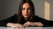 © Grosir - Intimate Portrait of a Young Woman With Dark Braided Hair Hazel Eyes and Soft Golden Light With Hands Resting on a White Surface Creating an Elegant Moody Scene