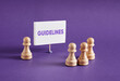 © Cagkan - Chess pawns standing next to the banner with the word Guidelines.