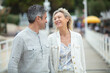 © auremar - mature couple walking outdoors and looking lovingly at each other