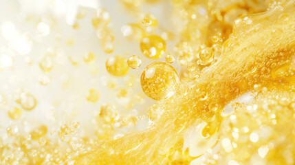 Poster - A yellow liquid with bubbles floating in it. The bubbles are small and scattered throughout the liquid. The image has a light and airy feel to it, with the bubbles adding a sense of movement