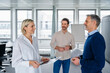 © Westend61 - Business meeting in a modern office with three people discussing and collaborating