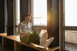 © Westend61 - Man working on a laptop in an office during sunset