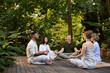 © Rido - Multiethnic group of people meditating outdoor
