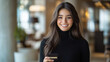 © ganlaya - a_beautiful_woman_smiling_confidently_while_holding_a_credit_card_in_a_modern_office
