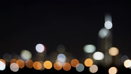 Poster - Nighttime urban landscape blanketed in glowing bokeh, transforming city lights into mesmerizing orbs of luminous color and ethereal radiance