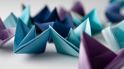 Poster - Close-up of blue and purple origami paper boats, creating a textured, abstract arrangement symbolizing teamwork, journey, or a fleet of ideas