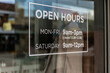 © Austockphoto - White open hours sign in glass window