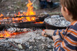 © Austockphoto - Young boy toasting a marshmallow on a campfire
