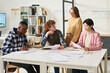 © Mediaphotos - Multiracial group of students engaging in studying foreign languages in classroom with various study materials and discussion happening among participants