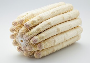 A bundle of white asparagus spears in a net bag on a white background in a studio setting