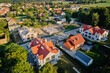 © Lazy_Bear - Aerial view of residential neighborhood with modern houses and construction site. Concept of real estate development and suburban living