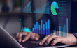 © sarach - Financial graphs and table calculations. Businessman using laptop computer to analyze business terms, business management analysis using spreadsheet software, finance.