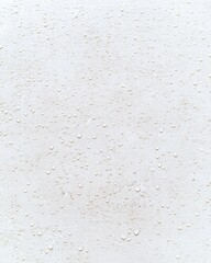 Poster - Close-up photo of water droplets on a smooth white surface capturing light and reflection effect