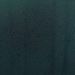 Poster - Raindrops glistening on a window pane creating a relaxing atmosphere on a rainy day
