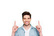 © deagreez - Photo of amazing guy indicating fingers up to empty space advising cool low shopping prices wear casual denim shirt isolated green color background