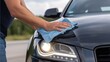 © SerPak - Car maintenance with hand cleaning headlight in summer for shine and care.